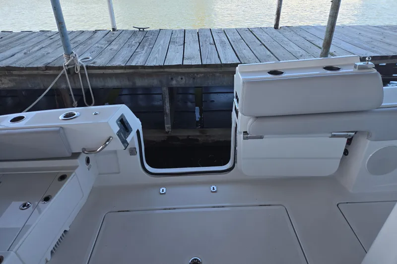 Slide: The Image of 2024 HCB 53 FT Suenos boat interior with open side door near dock. - 45