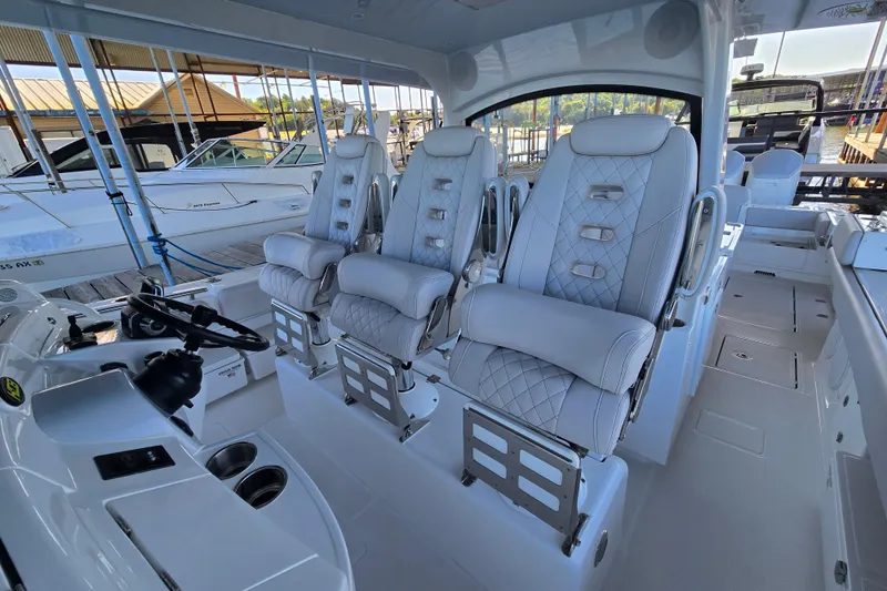 Slide: The Image of 2024 HCB 53 FT Suenos boat interior with luxurious seating and modern helm. - 49