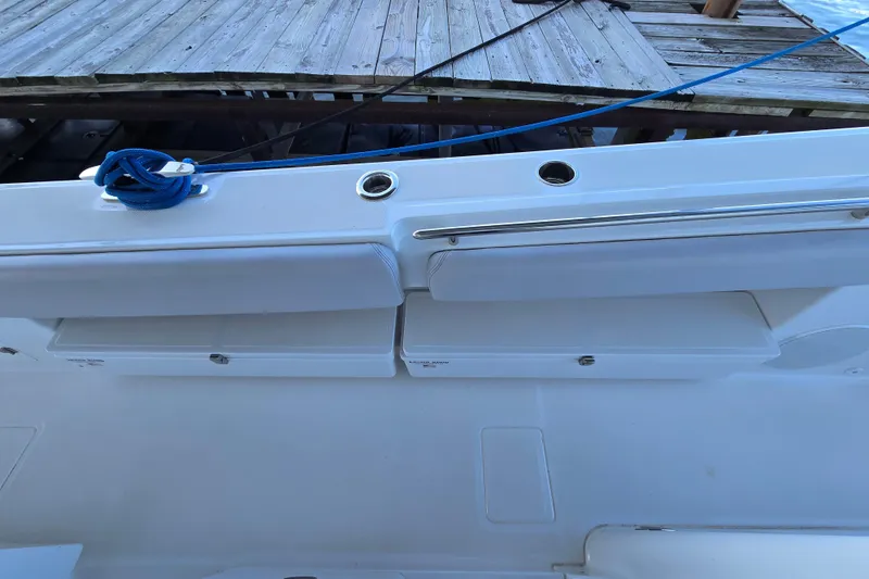 Slide: The Image of 2024 HCB 53 FT Suenos boat deck with storage compartments and blue rope. - 52