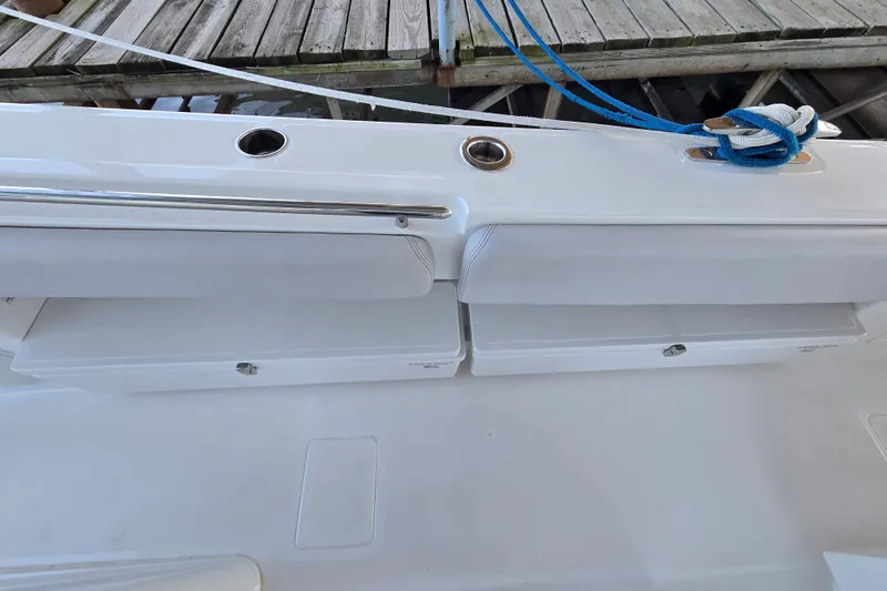 Slide: The Image of 2024 HCB 53 FT Suenos boat deck with storage compartments and docked rope. - 53