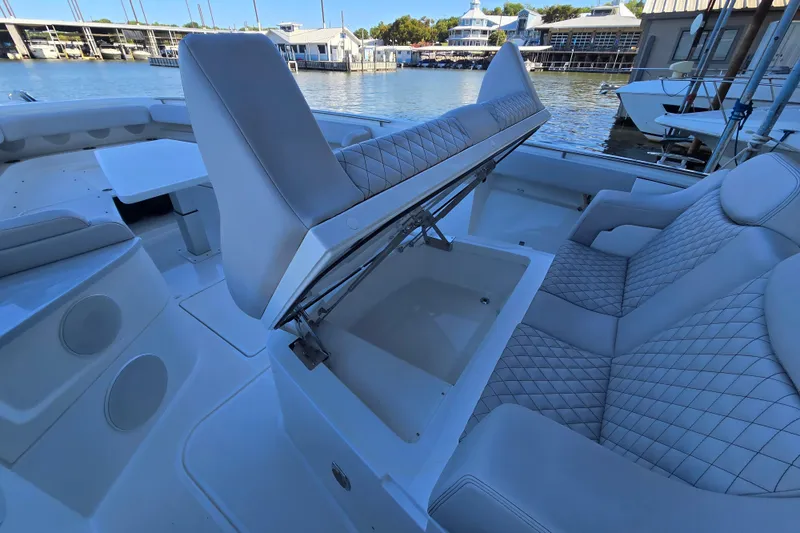 Slide: The Image of 2024 HCB 53 FT Suenos boat interior with luxurious seating and storage compartment. - 56