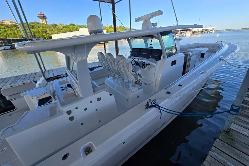 Slide: The Image of 2024 HCB 53 FT Suenos luxury boat docked at marina, showcasing sleek design and advanced features. - 59