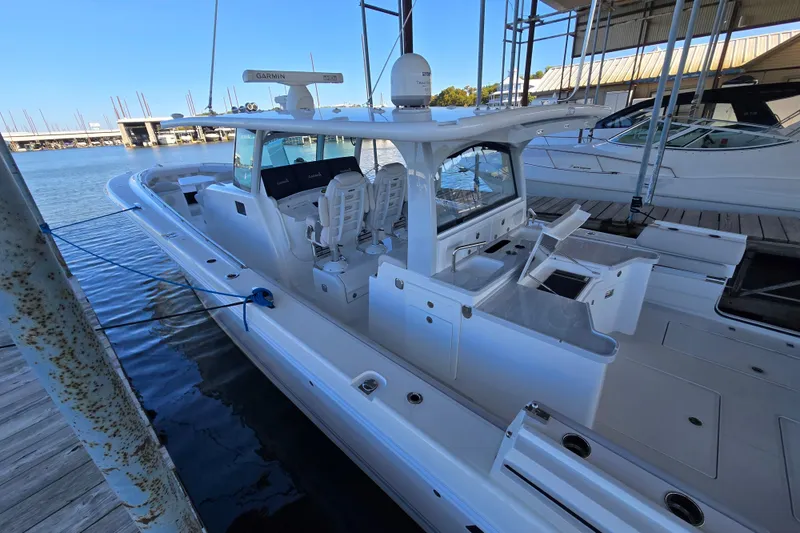 Slide: The Image of 2024 HCB 53 FT Suenos boat docked, featuring sleek design and advanced navigation equipment. - 62
