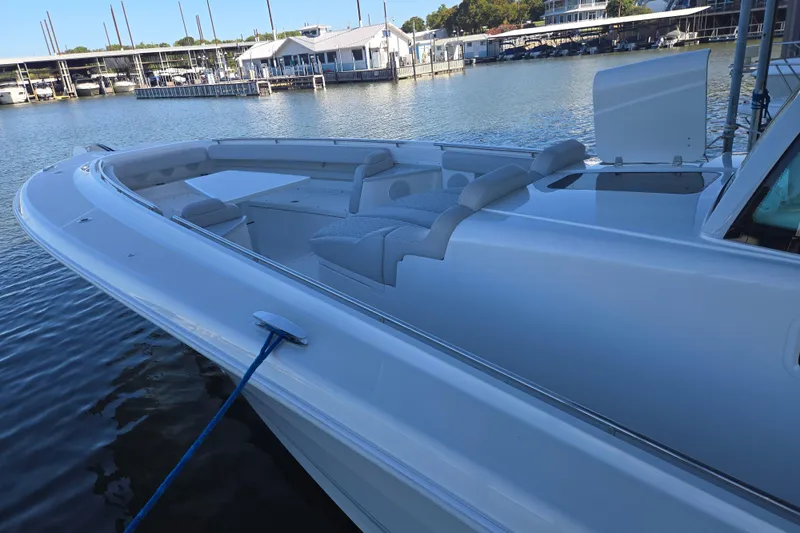 Slide: The Image of 2024 HCB 53 FT Suenos luxury boat docked at marina, showcasing sleek design. - 63