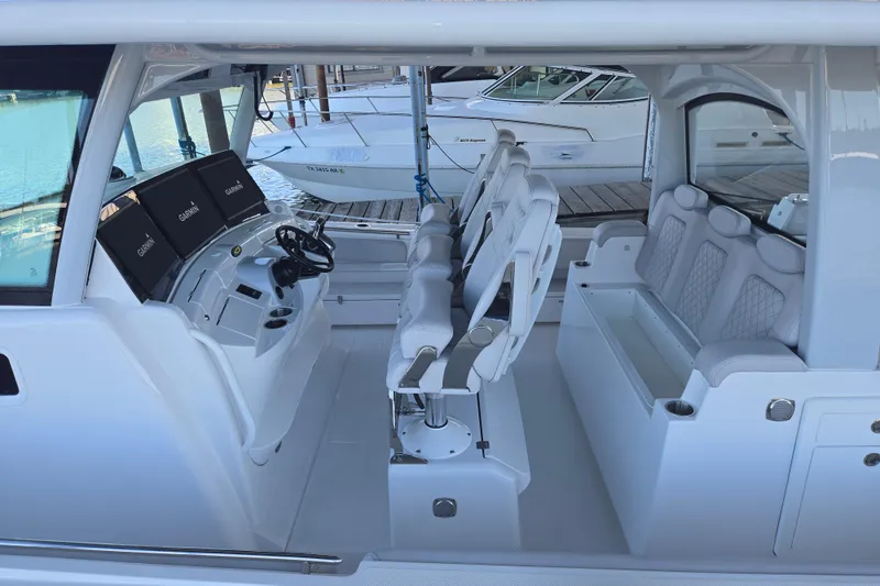 Slide: The Image of 2024 HCB 53 FT Suenos boat interior with helm and seating area. - 64