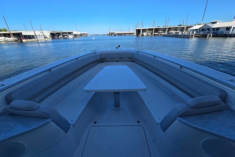 Slide: The Image of 2024 HCB 53 FT Suenos boat interior with table, docked at marina. - 68
