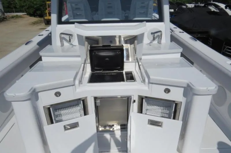 Slide: The Image of 2024 HCB 53 FT Suenos yacht with open storage compartments and grill. - 8