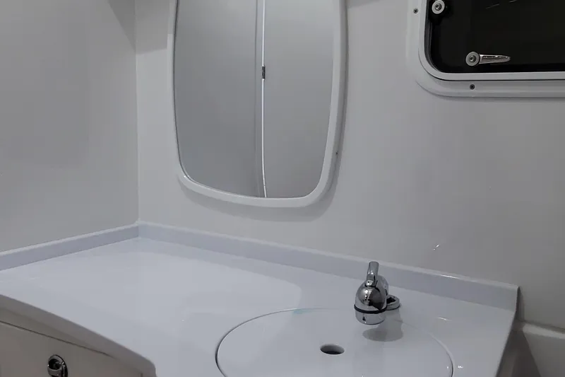 Slide: The Image of 2023 HCB 39 FT Speciale boat bathroom with sleek white sink and mirror. - 30