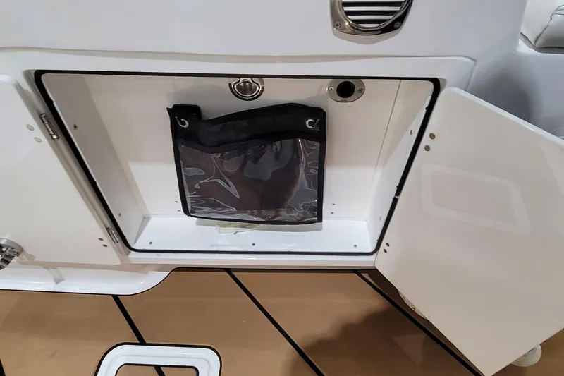 Slide: The Image of Open storage compartment on 2023 HCB 39 FT Speciale boat, featuring a mesh pocket. - 35