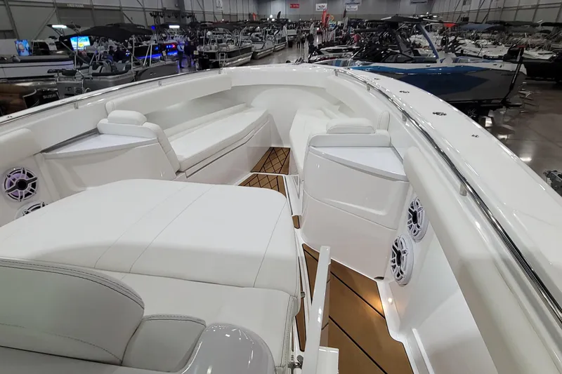 Slide: The Image of 2023 HCB 39 FT Speciale boat interior with luxurious seating and modern design at a boat show. - 52