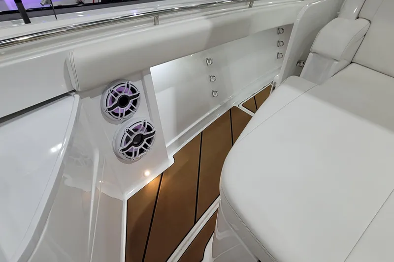 Slide: The Image of 2023 HCB 39 FT Speciale boat interior with white seating and built-in speakers. - 58