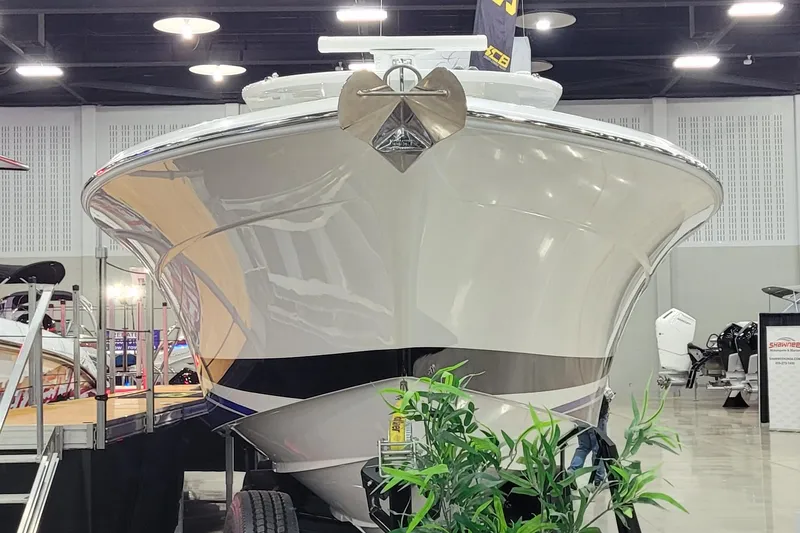 Slide: The Image of 2023 HCB 39 FT Speciale boat displayed indoors with plants in foreground. - 6