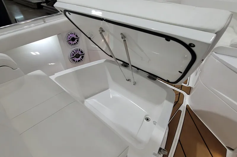 Slide: The Image of 2023 HCB 39 FT Speciale boat interior with open storage compartment and speakers. - 60