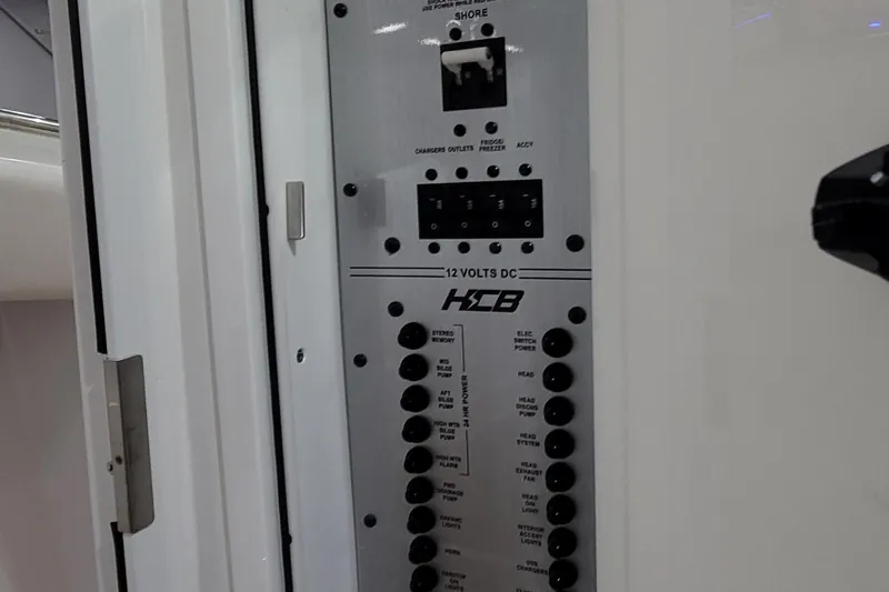 Slide: The Image of Electrical panel of 2023 HCB 39 FT Speciale boat, featuring 12 volts DC controls. - 63