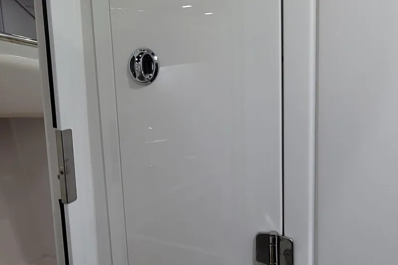 Slide: The Image of 2023 HCB 39 FT Speciale cabin door with sleek white finish and chrome handle. - 64