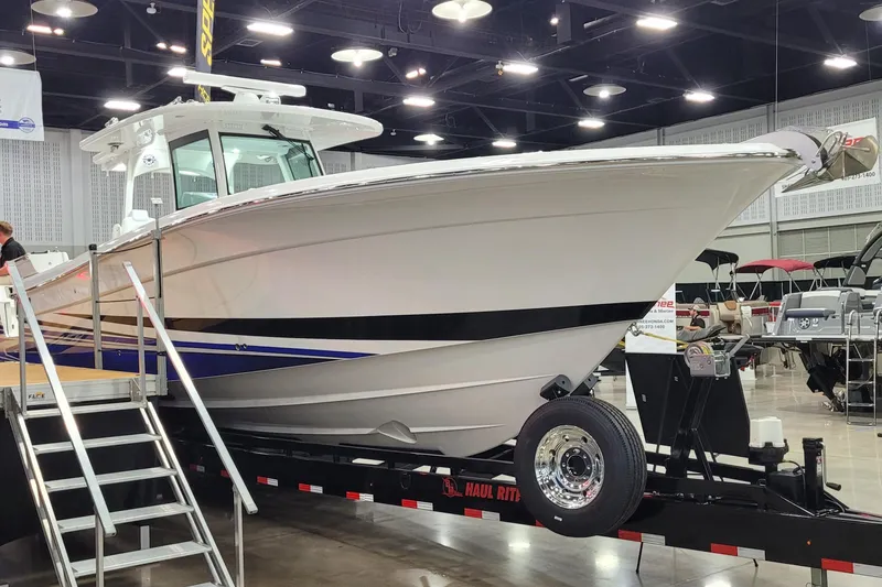 Slide: The Image of 2023 HCB 39 FT Speciale boat displayed indoors on a trailer. - 7