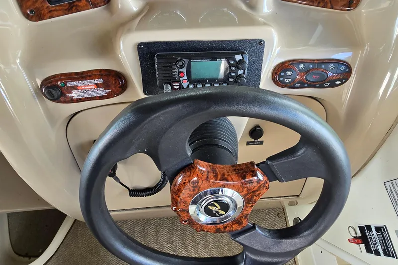 Slide: The Image of Steering wheel and dashboard of a 2004 Sea Ray 260 Sundancer boat. - 10