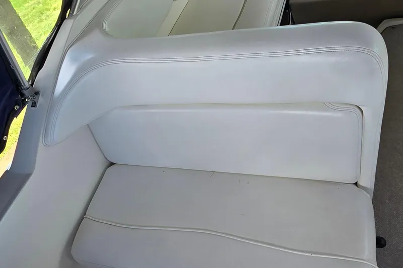 Slide: The Image of White leather seating on 2004 Sea Ray 260 Sundancer boat interior. - 15