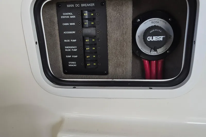 Slide: The Image of Control panel of a 2004 Sea Ray 260 Sundancer boat with switches and battery selector. - 22