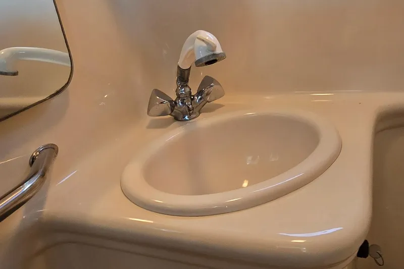 Slide: The Image of 2004 Sea Ray 260 Sundancer bathroom sink with chrome faucet and mirror. - 28