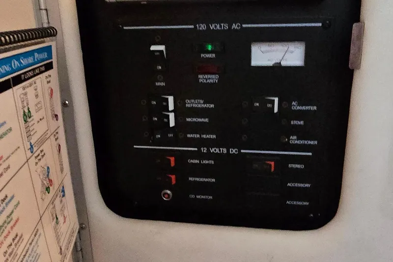 Slide: The Image of Electrical control panel on a 2004 Sea Ray 260 Sundancer boat. - 31