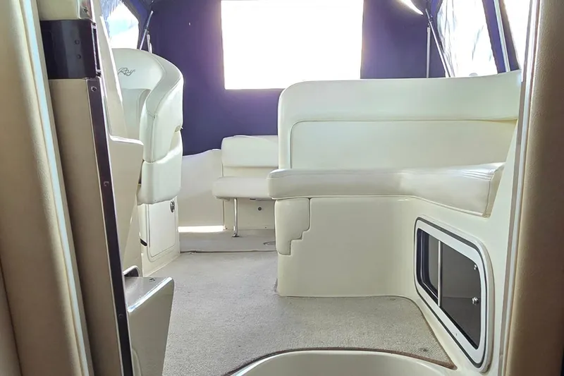 Slide: The Image of Interior of 2004 Sea Ray 260 Sundancer boat with beige seating and carpet. - 34
