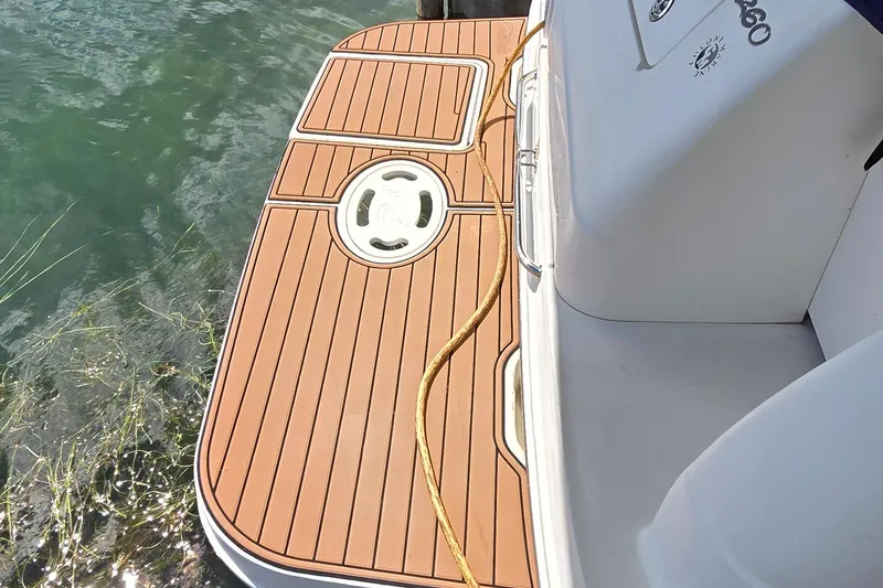 Slide: The Image of 2004 Sea Ray 260 Sundancer swim platform with teak decking and mooring rope. - 7