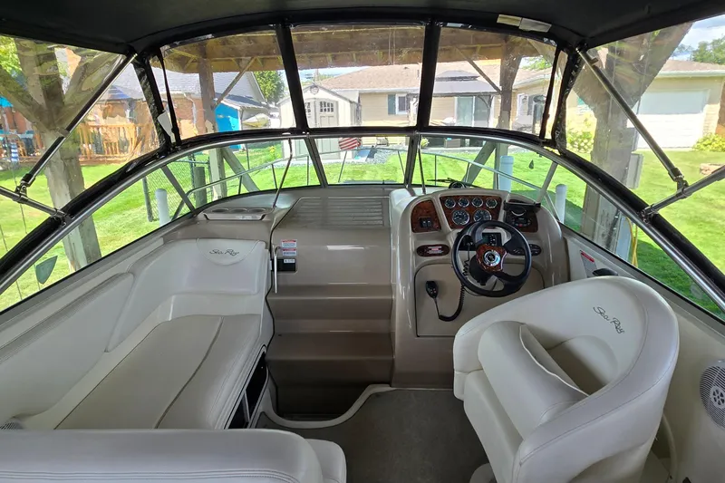 Slide: The Image of Interior view of 2004 Sea Ray 260 Sundancer boat cockpit with steering wheel and seating. - 8