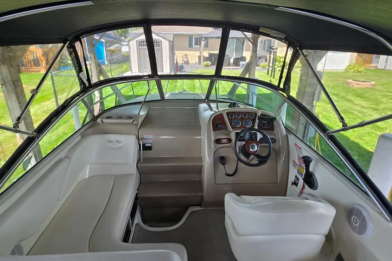 Slide: The Image of Interior view of 2004 Sea Ray 260 Sundancer boat cockpit with steering wheel and controls. - 9