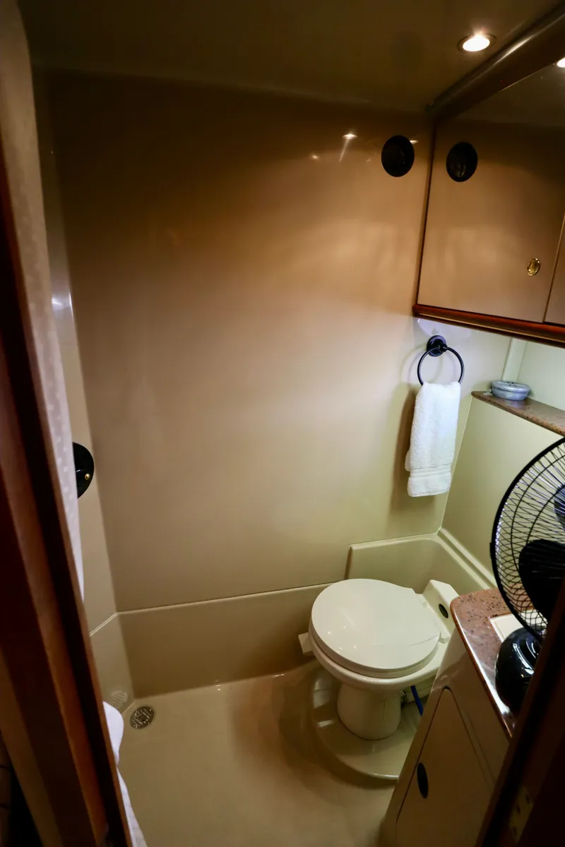 Slide: The Image of Bathroom of 2000 Cruisers Yachts 3870 with toilet and towel holder. - 10