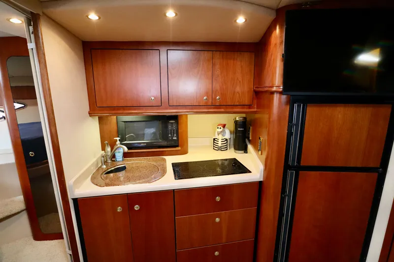 Slide: The Image of 2000 Cruisers Yachts 3870 kitchen area with wooden cabinets. - 11