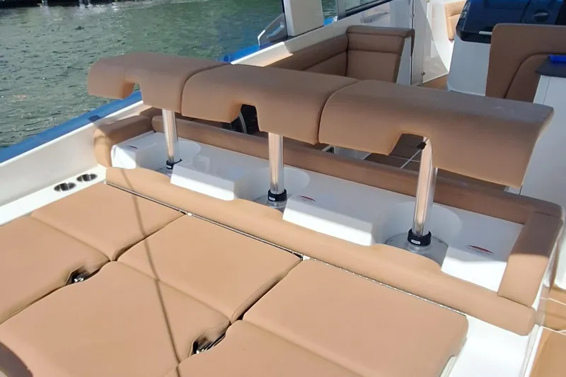 Slide: The Image of 2021 Aviara AV32 OB boat with tan seating and adjustable backrests on the water. - 10