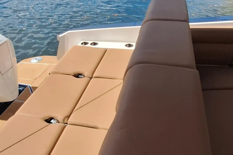 Slide: The Image of 2021 Aviara AV32 OB boat with tan seating, docked on water. - 11