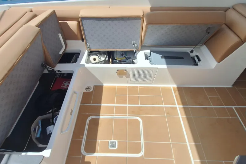 Slide: The Image of 2021 Aviara AV32 OB boat interior storage compartments with tan seating and teak flooring. - 18