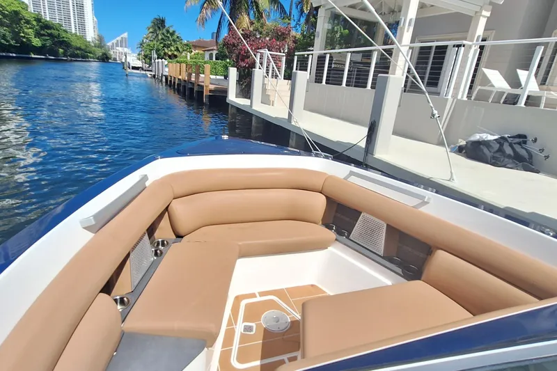 Slide: The Image of Luxurious 2021 Aviara AV32 OB boat with tan seating, docked by a waterfront home. - 19