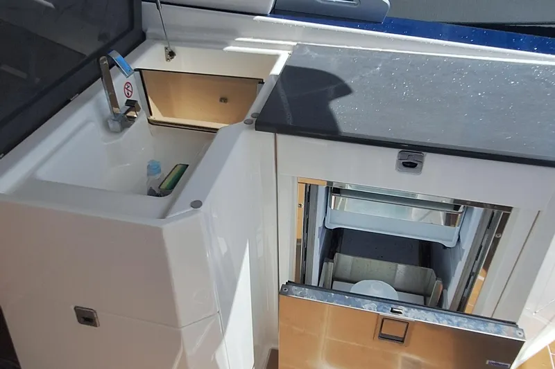 Slide: The Image of 2021 Aviara AV32 OB boat kitchenette with sink and storage compartments. - 21