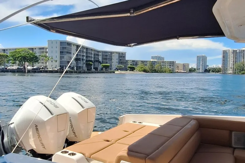 Slide: The Image of 2021 Aviara AV32 OB boat with twin Mercury engines on a scenic waterfront. - 7