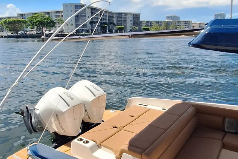 Slide: The Image of 2021 Aviara AV32 OB boat with twin Mercury outboard engines on a sunny waterfront. - 8