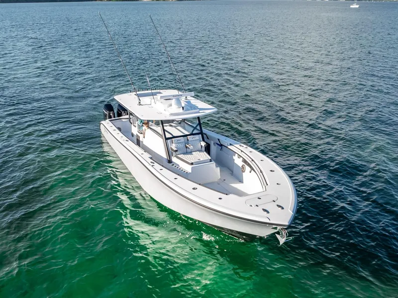 Slide: The Image of 2024 Yellowfin 42 boat cruising on clear blue water. - 27