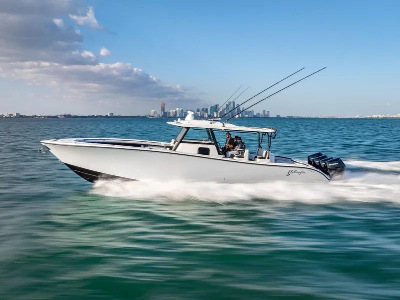 Slide: The Image of 2024 Yellowfin 42 boat cruising on open water with city skyline in the background. - 3