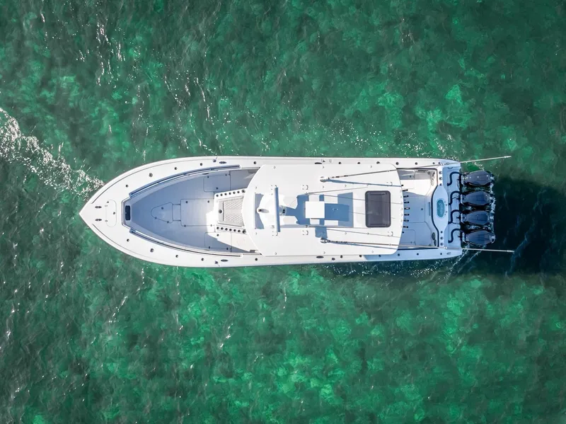 Slide: The Image of Aerial view of 2024 Yellowfin 42 boat cruising on clear turquoise water. - 32