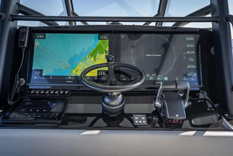 Slide: The Image of 2024 Yellowfin 42 boat dashboard with navigation screens and steering wheel. - 38