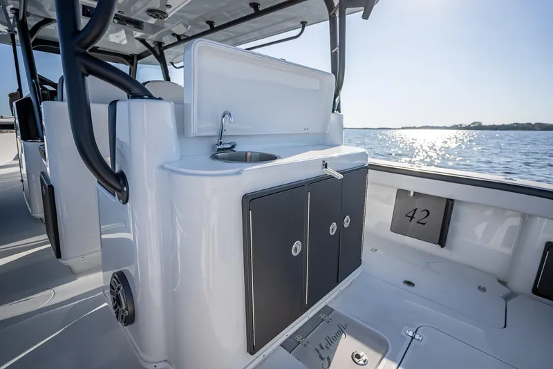 Slide: The Image of 2024 Yellowfin 42 boat interior with sink and storage compartments. - 49