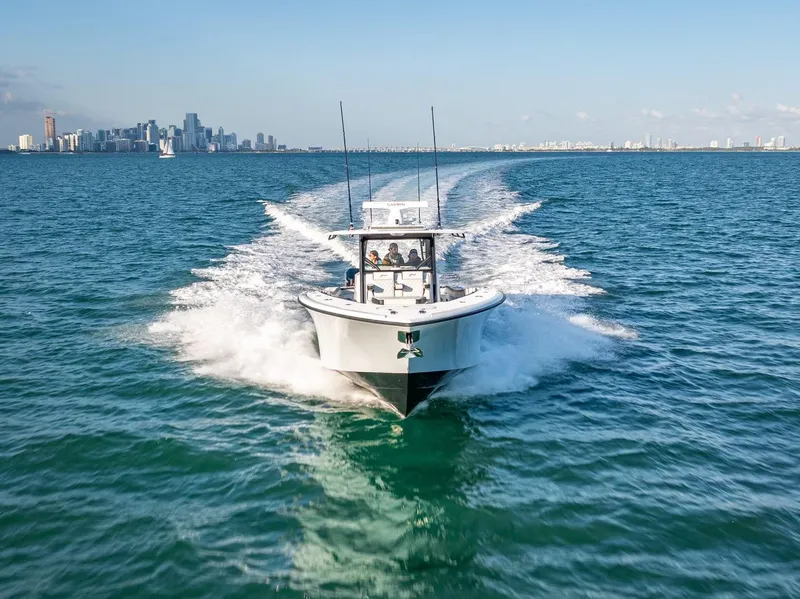 Slide: The Image of 2024 Yellowfin 42 boat cruising on open water near city skyline. - 9