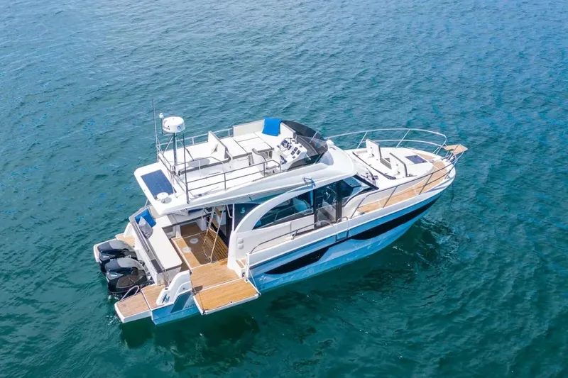 Slide: The Image of 2023 Beneteau Antares 11 Fly yacht on open water, aerial view. - 100