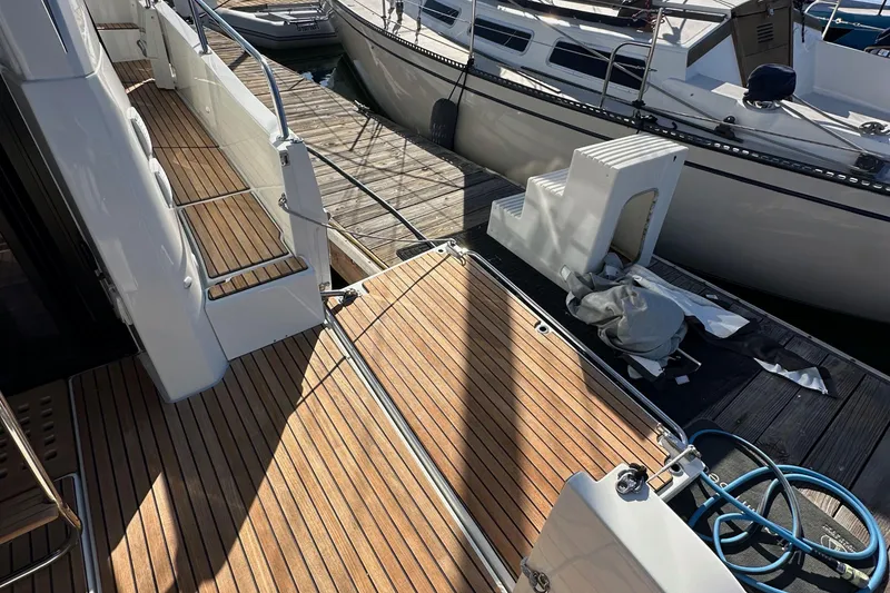Slide: The Image of 2023 Beneteau Antares 11 Fly yacht with teak deck at marina dock. - 13