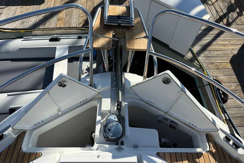 Slide: The Image of 2023 Beneteau Antares 11 Fly boat deck with open storage compartments and railing. - 20
