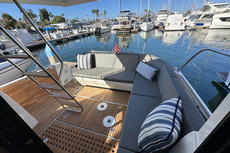 Slide: The Image of 2023 Beneteau Antares 11 Fly yacht with elegant seating at a marina. - 26