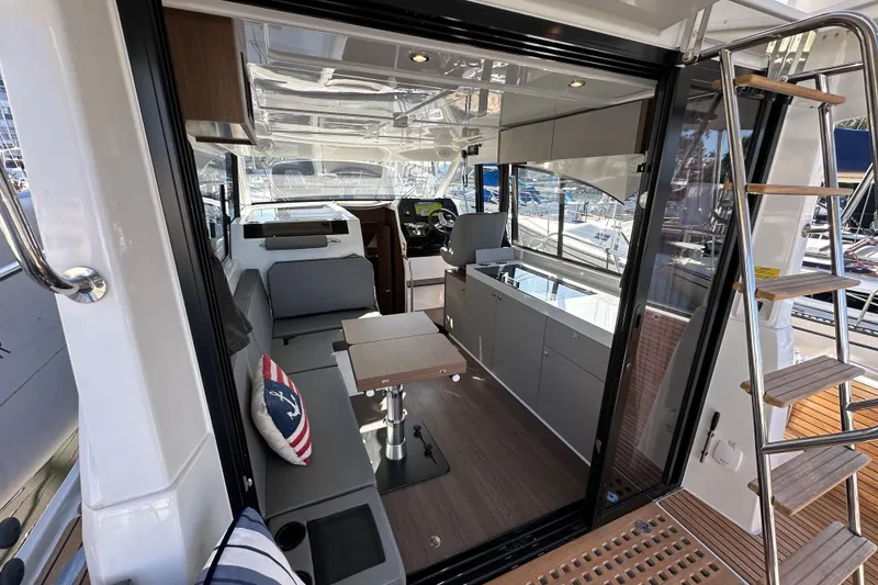 Slide: The Image of Interior view of 2023 Beneteau Antares 11 Fly yacht, featuring modern seating and helm. - 27