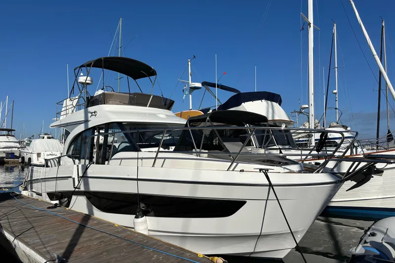 Slide: The Image of 2023 Beneteau Antares 11 Fly yacht docked at marina under clear blue sky. - 3